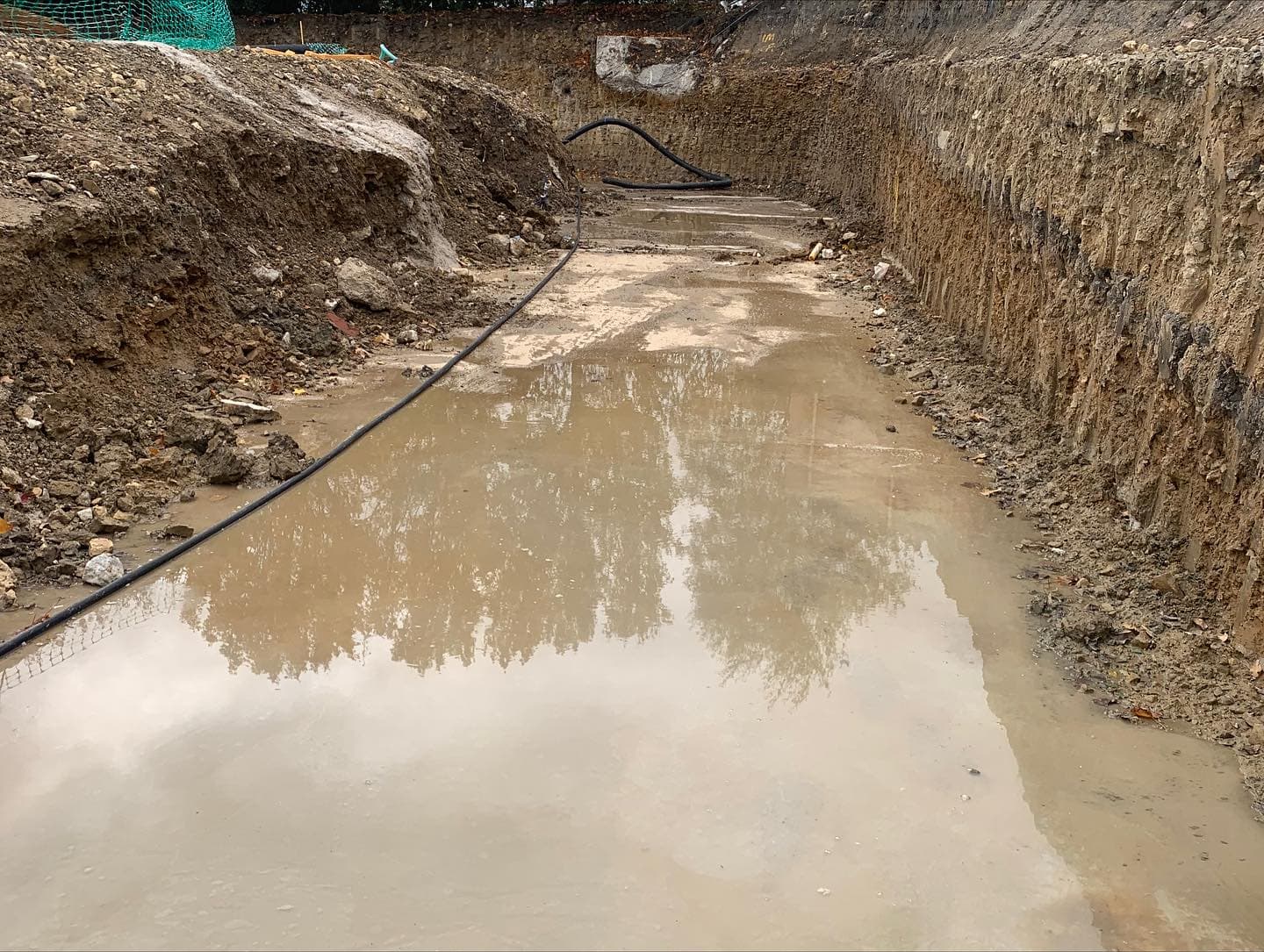 Large construction footings being cleared of water