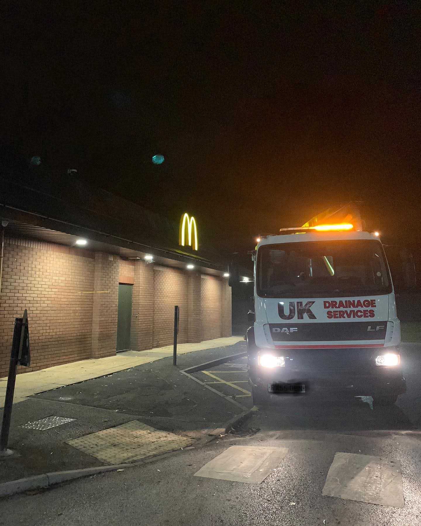 UK Drainage Services commercial tanker operating at night