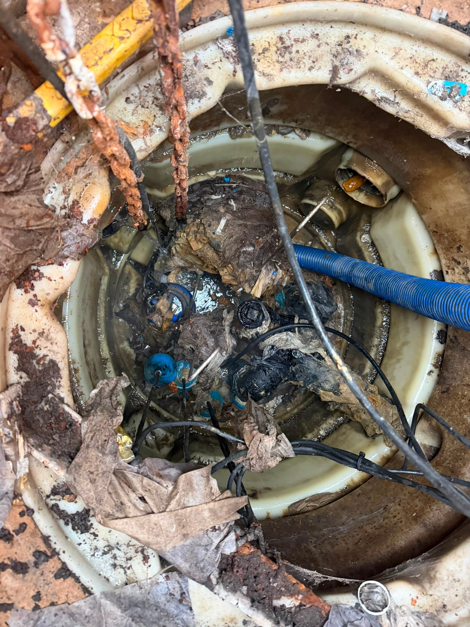 Care home pumping station wet well heavily blocked with rag waste before clearance