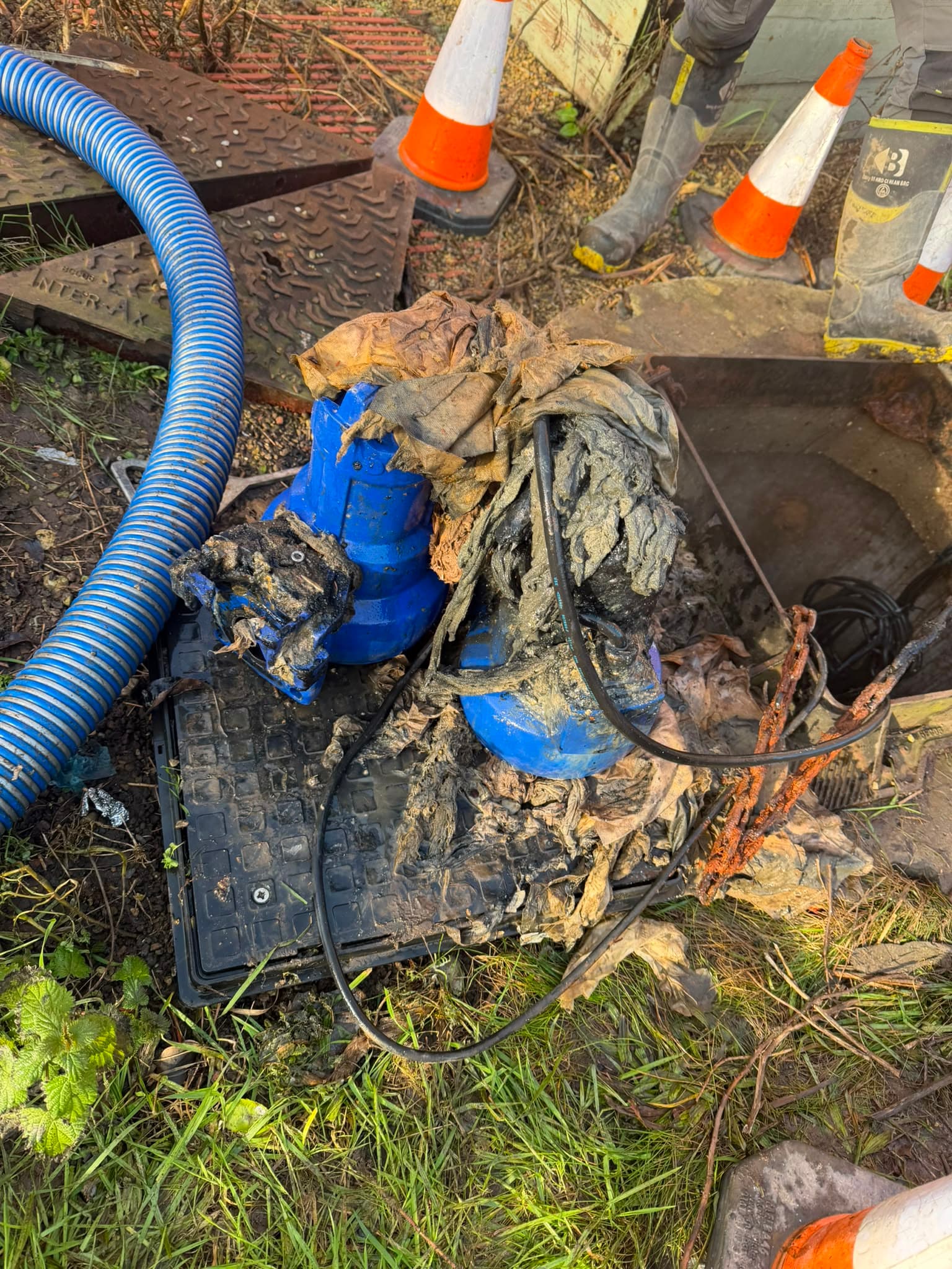 Both submersible pumps lifted from the wet well, caked in rag waste