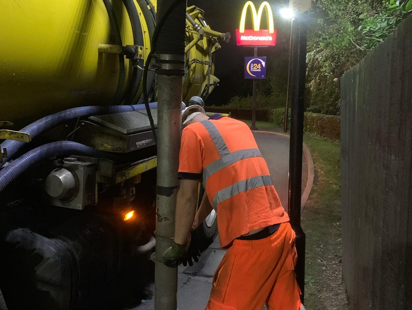 Engineer cleaning drains at McDonald's restaurant