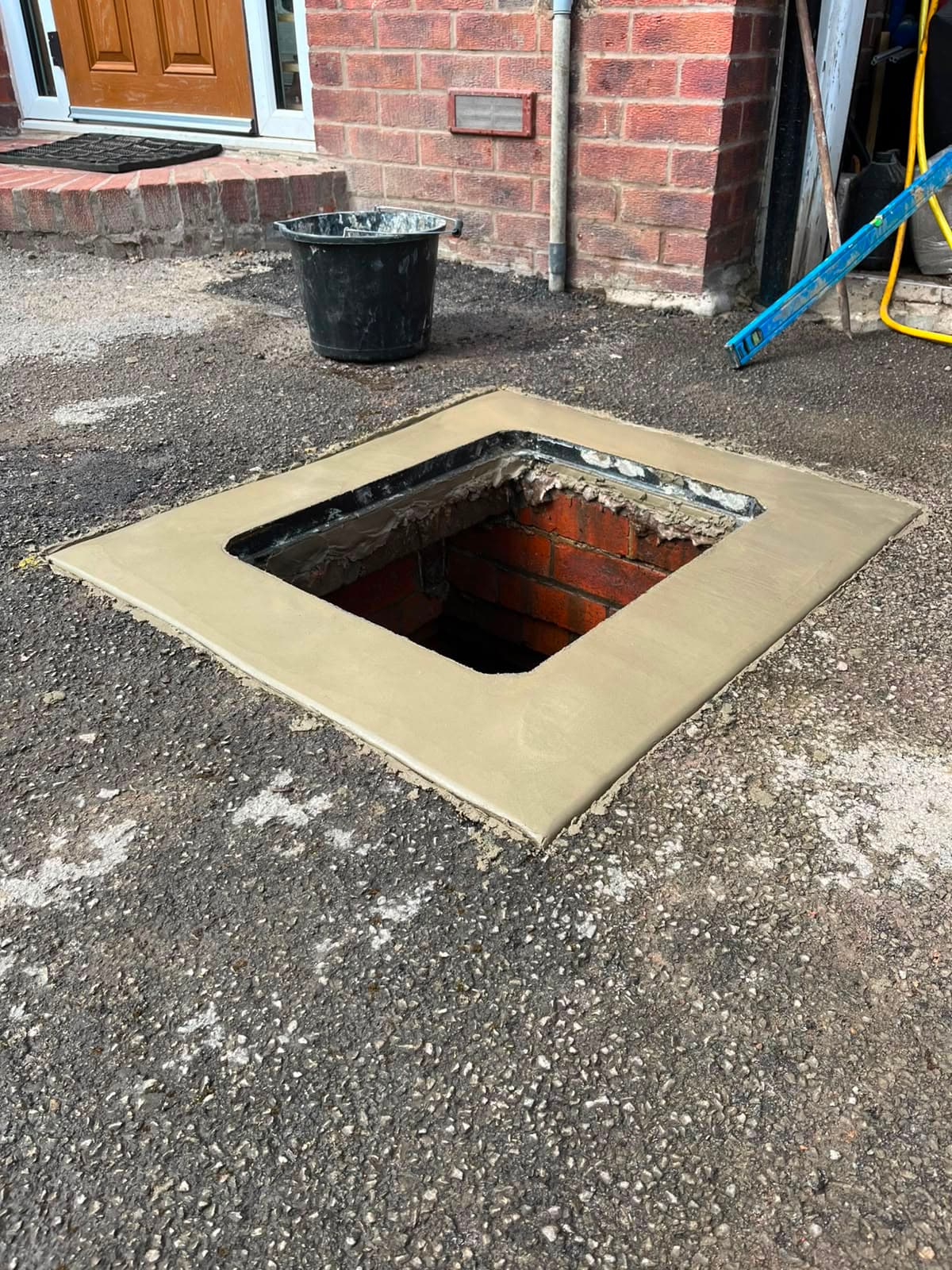 Manhole chamber prepared with a fresh 9-inch concrete border before the new frame was fitted