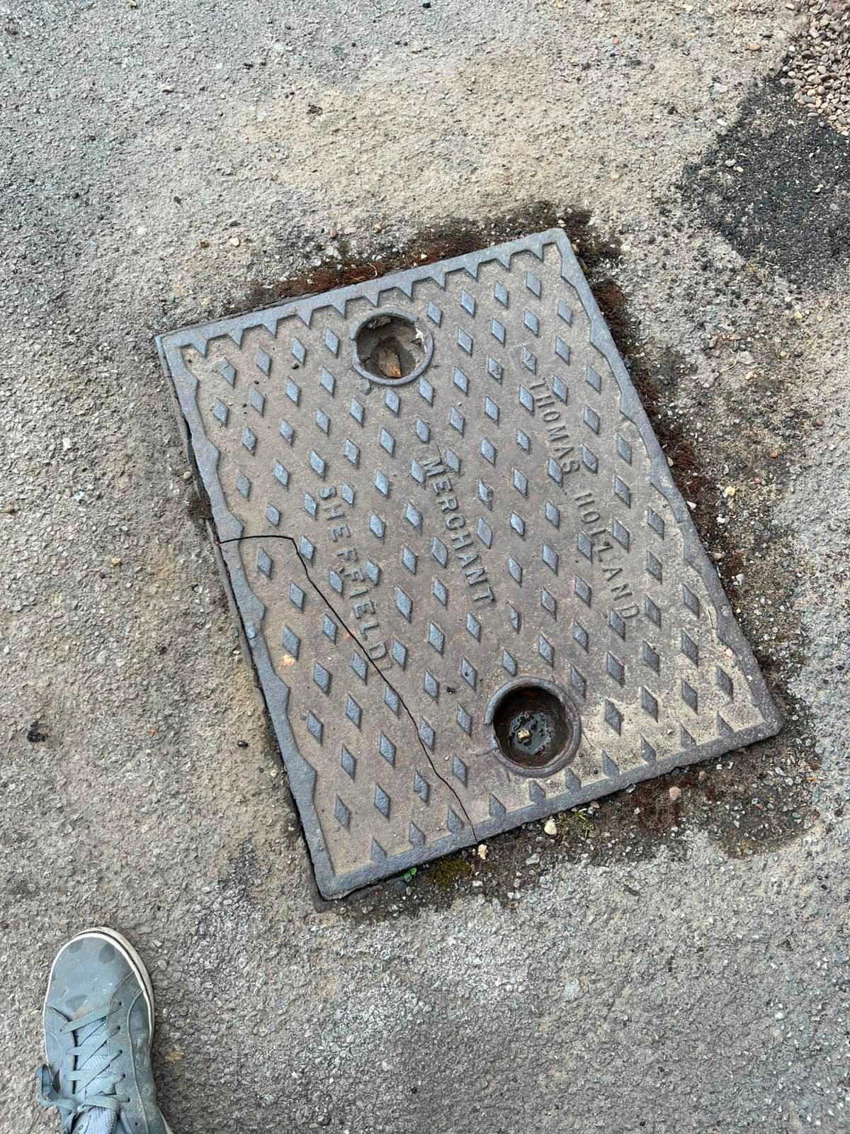 Old cast iron manhole cover in Sheffield cracked after a delivery van parked on it