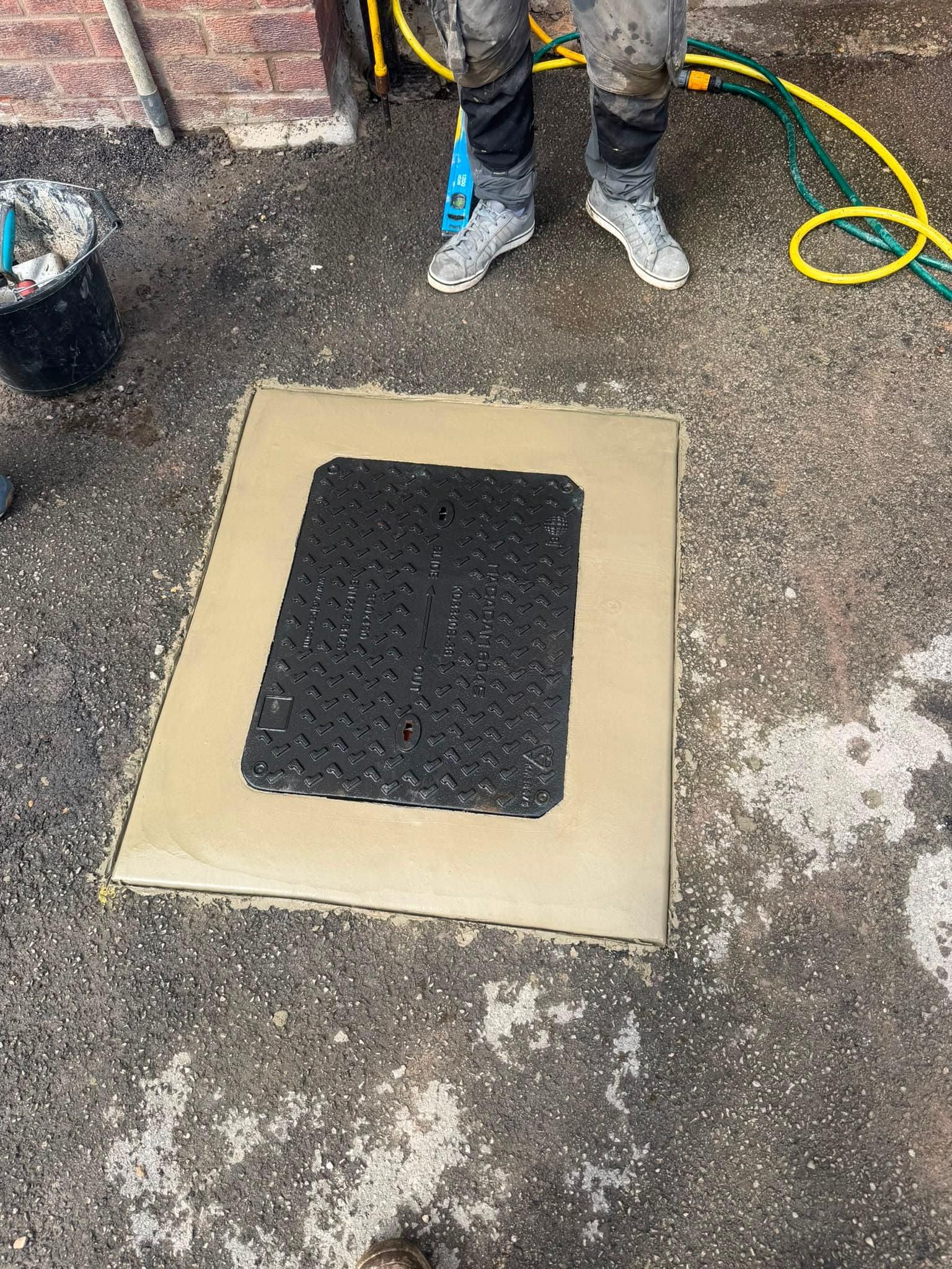 New B125-rated 12.5-tonne manhole cover and frame installed and bedded in the concrete surround